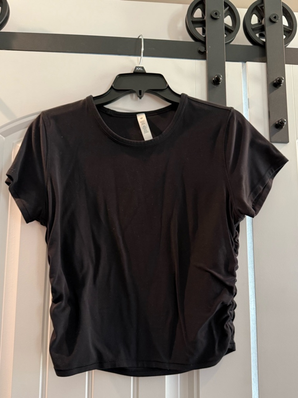 Lululemon black cropped shirt with side ruching.